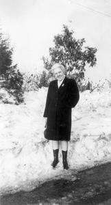 E. Alfreda Rebstock stands near the snowbank resulting from the snowstorm of 1947