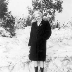 E. Alfreda Rebstock stands near the snowbank resulting from the snowstorm of 1947