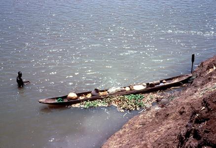 Cargo-laden Pirogue (Canoe) on the River Bank