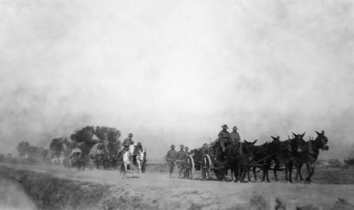 Soldiers of the US Army's 15th Infantry Regiment marching with horse-drawn carts.