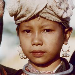 A Yellow Lahu (Lahu Shi) girl poses in her village in Houa Khong Province