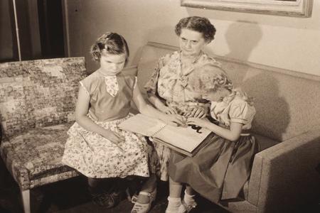 Two young girls working with their Braille tutor in Milwaukee, Wisconsin