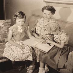 Two young girls working with their Braille tutor in Milwaukee, Wisconsin