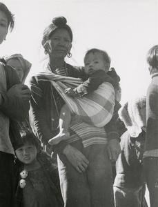 A Black Lahu (Lahu Na) mother carries her child in Houa Khong Province