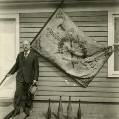 William Ahearn Sr. holds flag of the Two Rivers Turnverein (a German gymnastic movement)