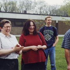 Psychology professor Margaret Hamilton laughs with students in courtyard