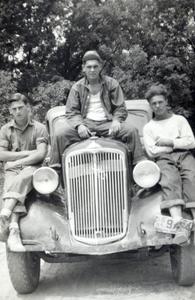 CCC workers sitting on a car