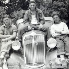 CCC workers sitting on a car