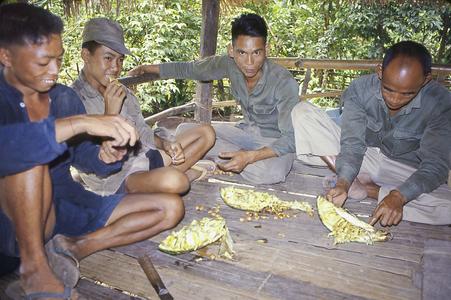 Men enjoying durian fruit