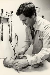 Doctor examines an infant
