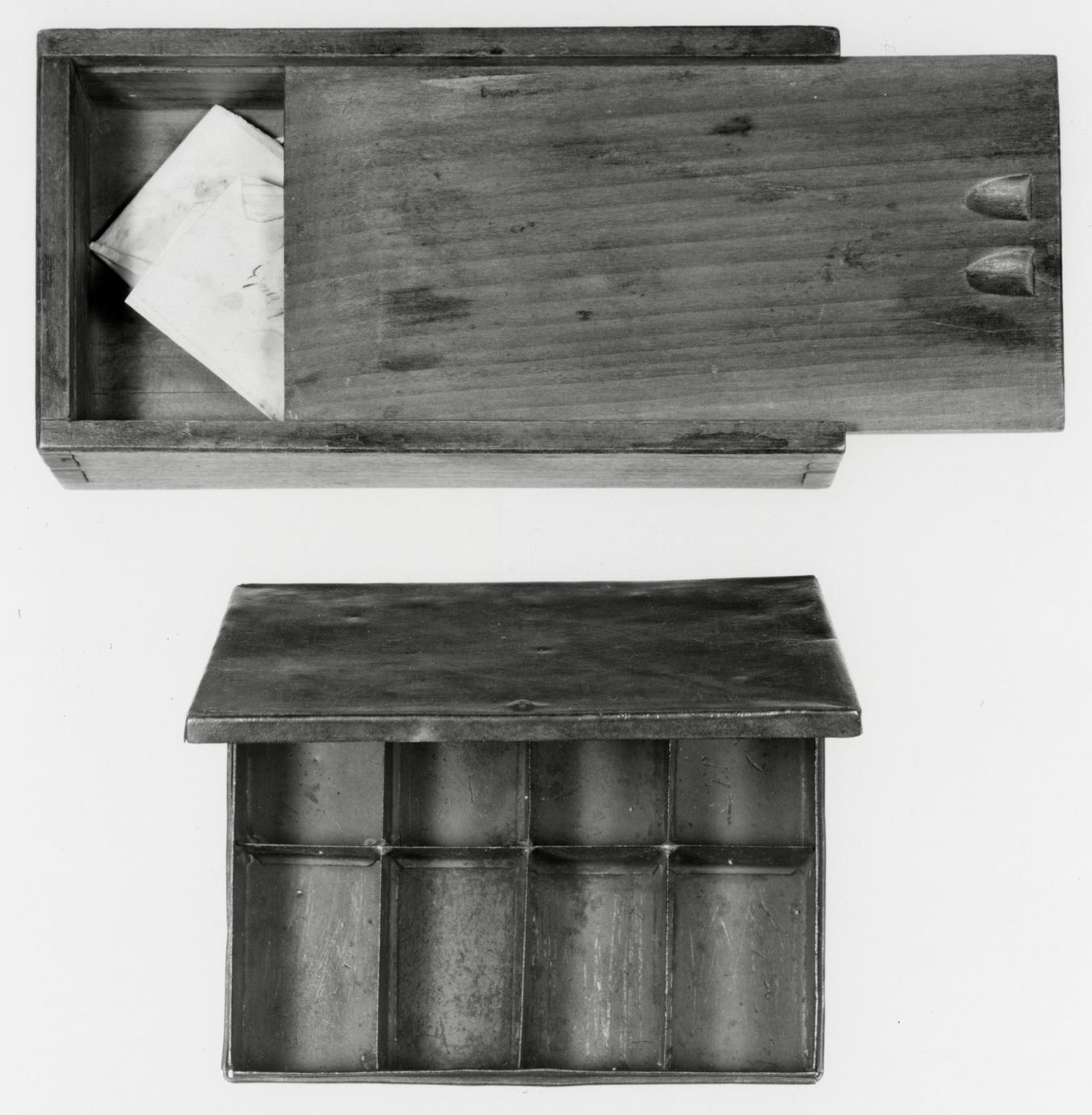 Black and white photograph of various boxes used to store various small items.