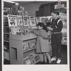 Children look at drugstore's record selection