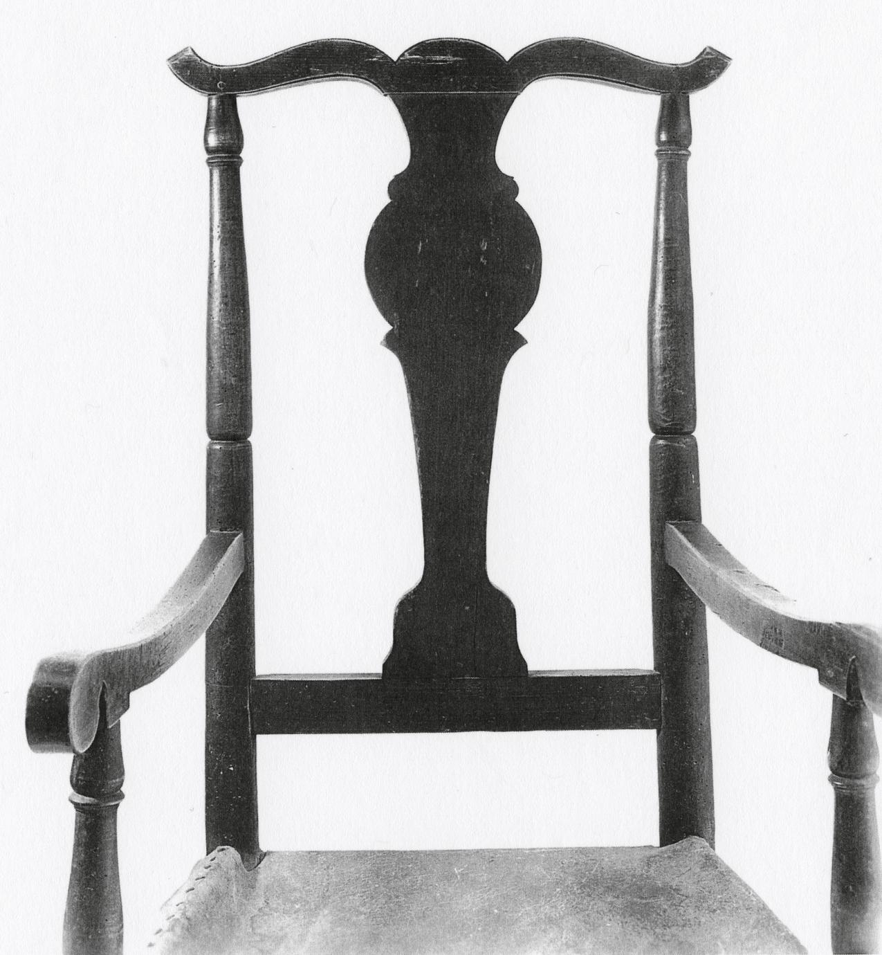Black and white photograph of a fiddle-back armchair with rockers.