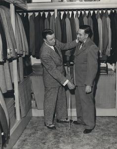 A tailor at work in a men's clothing store