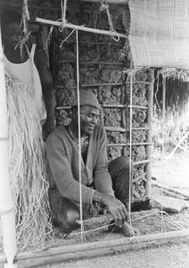 Man Weaving a Mat with Loom