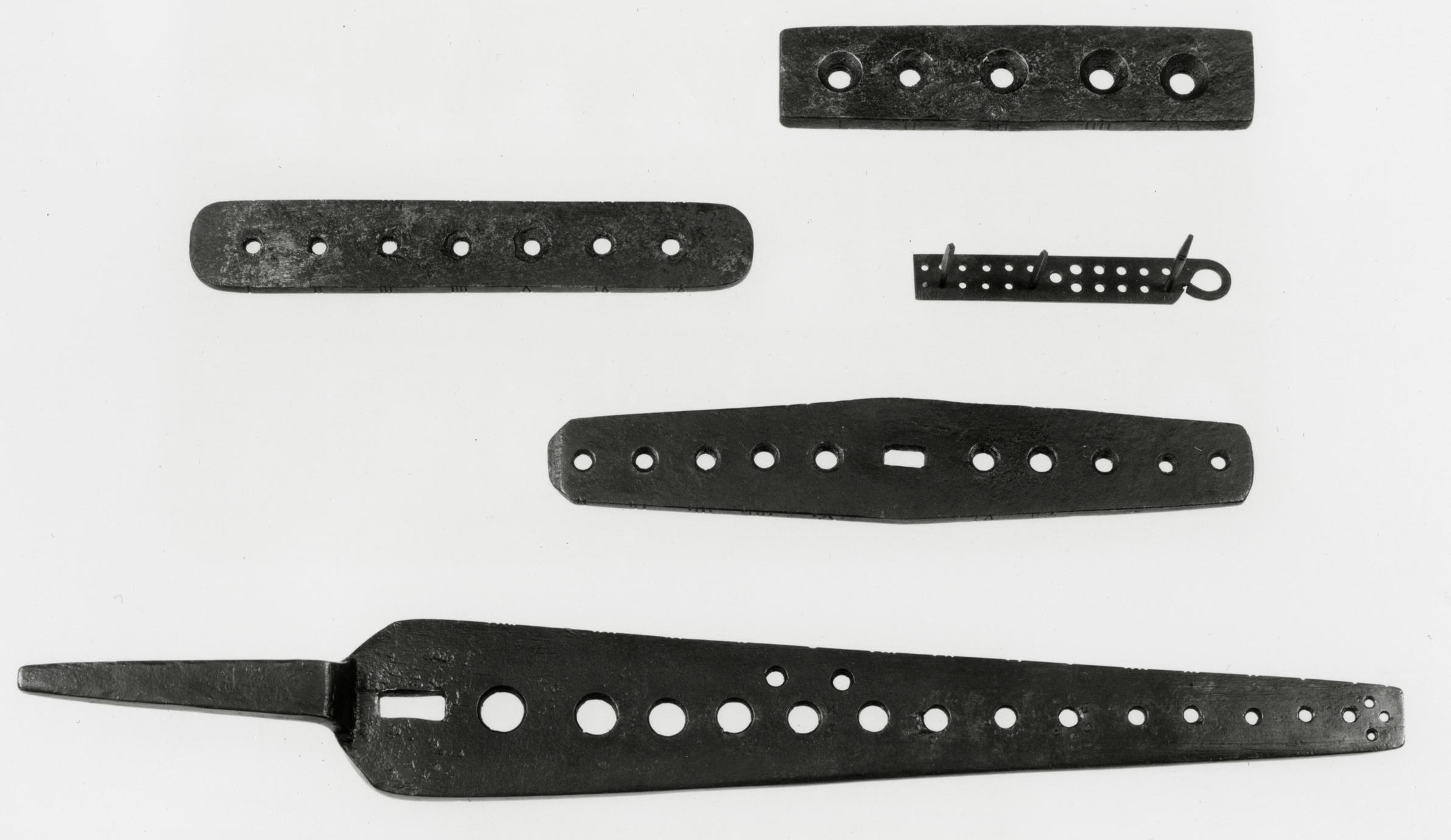 Black and white photograph of screw plates or dies.