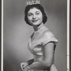 Tiara crowned woman poses with a smile