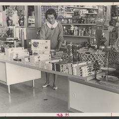 A woman views a candy display in a drugstore