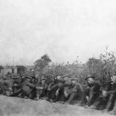 Soldiers of the US Army's 15th Infantry Regiment resting by the roadside.