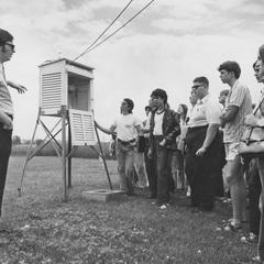 Professor Joseph Moran and a group of students at the Weather Station
