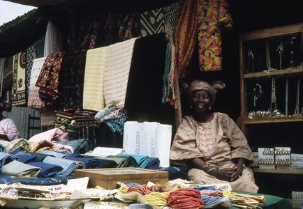 Mrs. Obe with fabric at Ilesa market