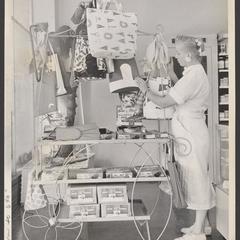 A saleswoman checks on a display of summer items