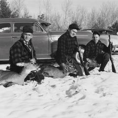 Hunters with their deer