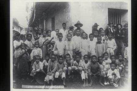 Filipino boys and girls on what is probably Calle Real, Cavite, 1899