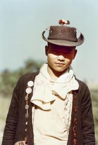 An Akha young man poses in traditional shirt and untraditional hat in Houa Khong Province