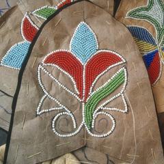 Close-up view of floral beadwork on moccasin vamps