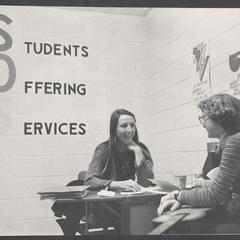 Two students conversing in the Students Offering Services (SOS) area