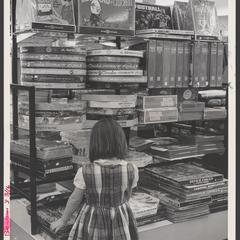 A young shopper views an assortment of puzzles in a drugstore display