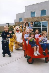 Corby the Cougar with children of the daycare