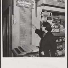 A woman views a list of doctors provided in a drugstore
