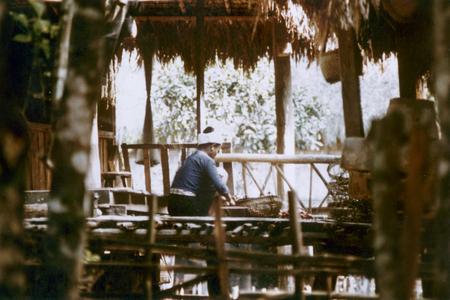 Woman working on the porch of her home in the Lu village of Ta Fa in Houa Khong Province