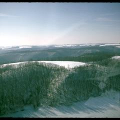Aerial view of the Kickapoo watershed in winter with a cultivated field on top of one hill