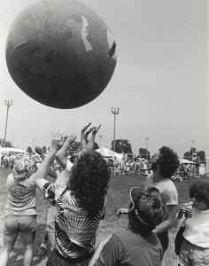 Students playing with Earth Ball at event near the campus soccer fields