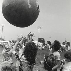 Students playing with Earth Ball at event near the campus soccer fields