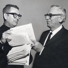 Edwin Young receives a petition from professor Reid Bryson