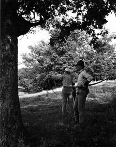Aldo Leopold and another with bows and arrows