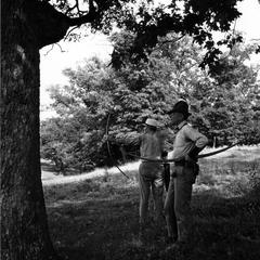 Aldo Leopold and another with bows and arrows