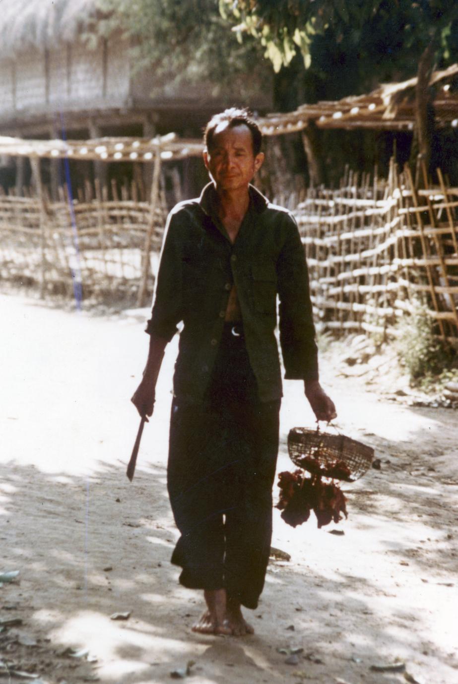 Male villager in the Lu village of Ta Fa in Houa Khong Province, carrying food from the village market