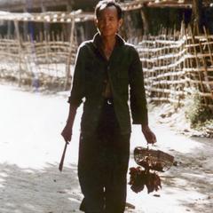 Male villager in the Lu village of Ta Fa in Houa Khong Province, carrying food from the village market