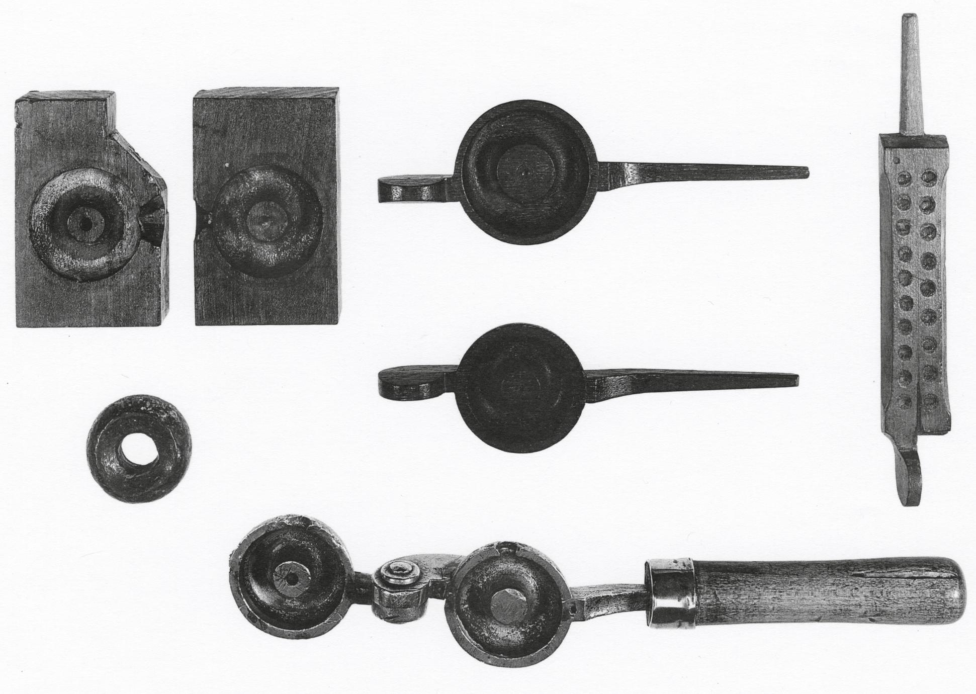 Black and white photograph of patterns for counterweight and seine net sinker molds, pattern for a shot mold, counterweight and seine net sinker, and counterwieght and seine net sinker mold.