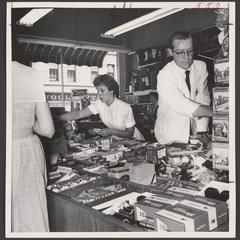 Salesclerks work at a busy drugstore counter