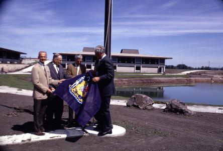 Governor Knowles raising Wisconsin state flag, UW Fond du Lac
