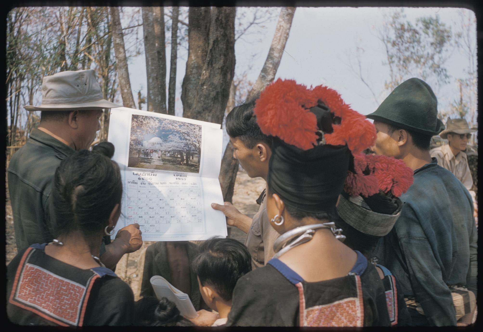 Hmong (Meo) and Inspector of Education with calendar