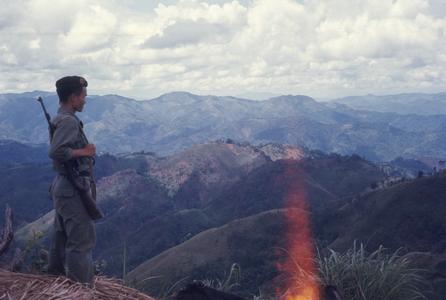 Soldier overlooking mountains