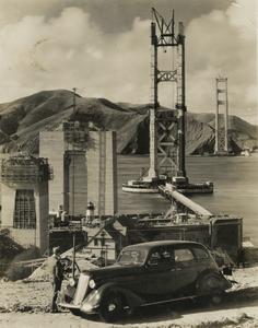 A Nash automobile overlooks the construction of the Golden Gate Bridge