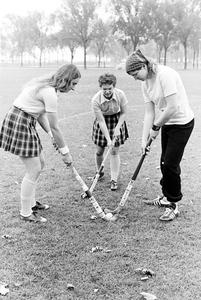 Three female field hockey players